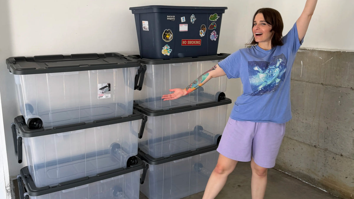 House of Caswell founder Kaylie Caswell smiling beside six large empty storage totes before bringing the brand’s inventory and fulfillment home.