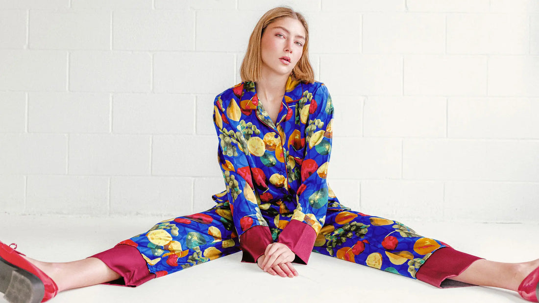 Model wearing a vibrant fruit-print silk set featuring bold color, tailored silhouette, and expressive pattern design by Kaylie Caswell